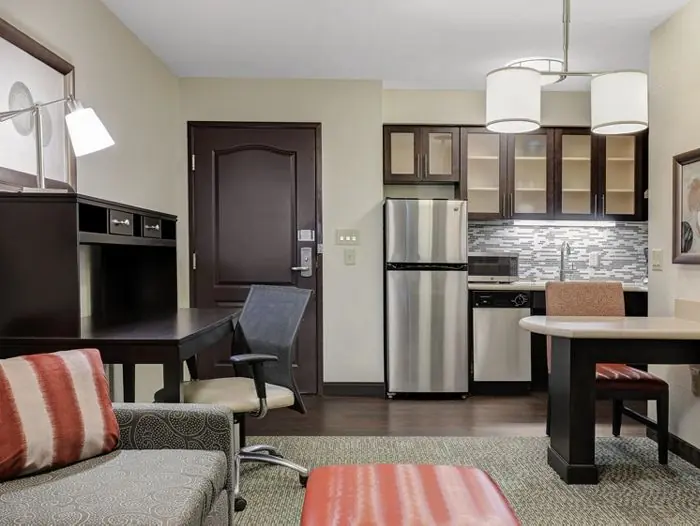 Kitchen, dining table and living area with sofa.